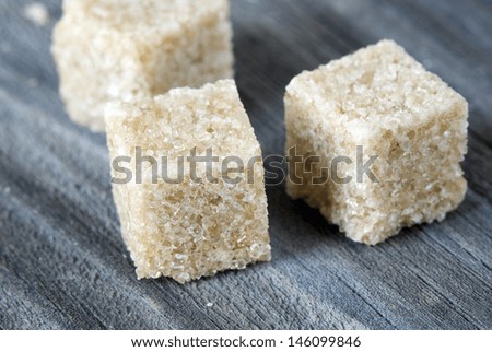 pieces of cane sugar on a wooden board