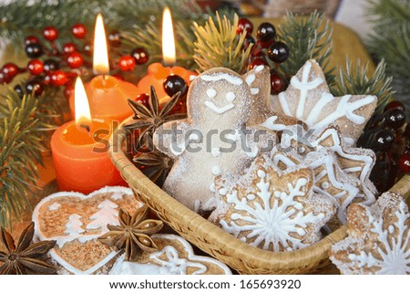 Christmas decoration with cookies, gingerbread man and burning candles