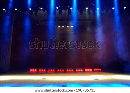 View from the illuminated empty concert stage to the dark auditorium