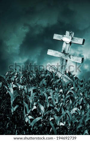 Wooden grave cross on background of the night sky storm