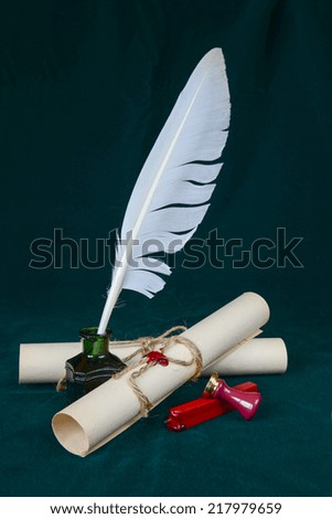 White feather in the inkwell, sealing wax, signet and two paper scroll on dark-green cloth