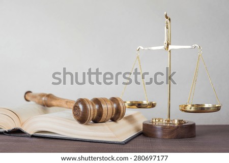 Symbols of law: wood gavel, soundblock, scales and opened volumetric old books, with space for text