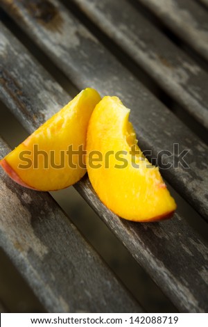 Pieces of fresh peach on a wooden table