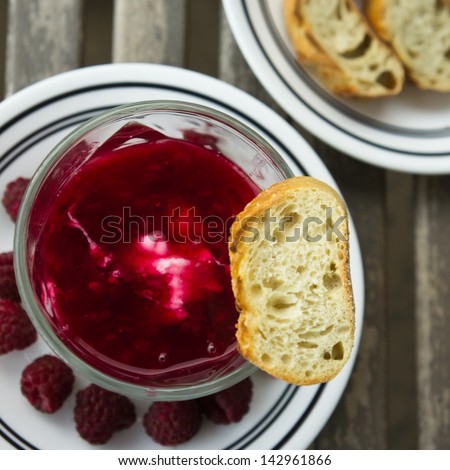 Dessert organic yogurt with raspberry jelly and french baguette view from top square