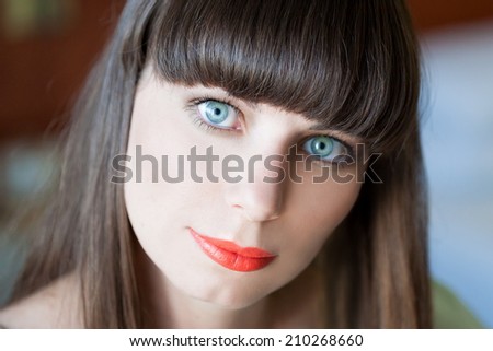 face woman with brown hair and blue eyes in nature