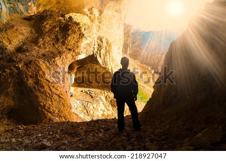 beautiful  man  mainsail  and cave mountains background
