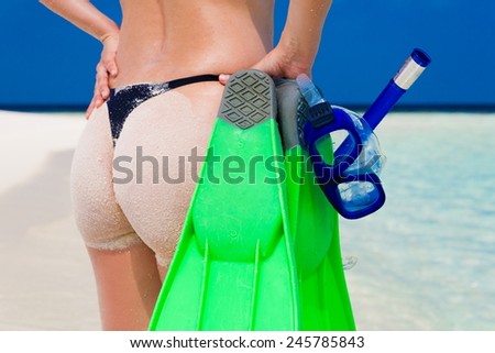 beautiful women ass with flippers, mask and tube snorkeling in Maldives  romantic  atoll island paradise luxury  resort about coral reef