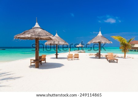 beautiful white parasol and sunbed in sea tropical  Maldives  romantic  atoll island paradise luxury  resort about coral reef