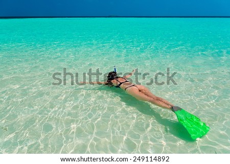 beautiful women  with flippers, mask and tube snorkeling in Maldives  romantic  atoll island paradise luxury  resort about coral reef