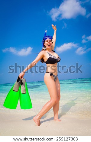 beautiful women in bikini  with flippers, mask and tube snorkeling on romantic  atoll island paradise luxury  resort about coral reef