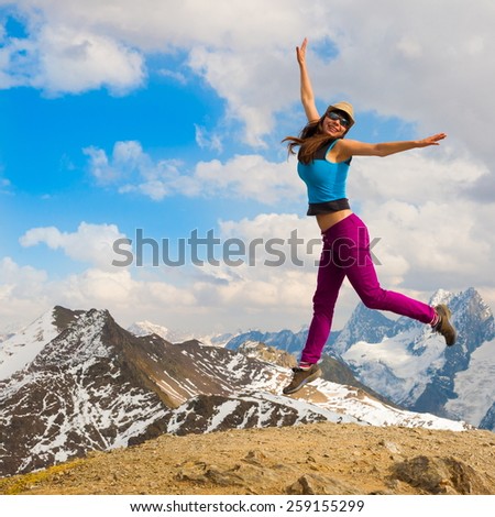 A woman jump in beautiful  mountain  day autumn  landscape  background