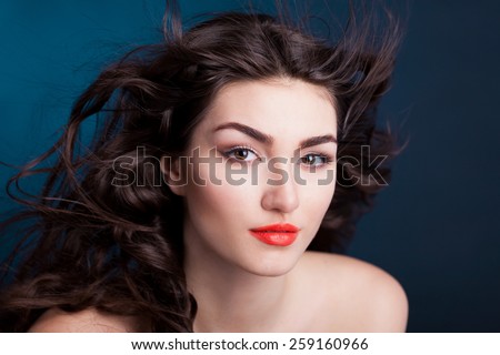beautiful sensuality elegance lady woman serious face with brown eyes, studio portrait and professional light, nature romantic wellness pure makeup, gloss on the hair brunette, blue background