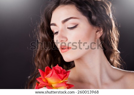 beautiful elegance lady woman serious face with brown eyes and red flowers rose, studio portrait and professional light, nature romantic wellness pure makeup, gloss  hair brunette, black background
