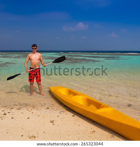 beautiful man with yellow canoe blue sun sea tropical nature background holiday luxury  resort island atoll about coral reef, sport adventure activity lifestyle entertainment kayaking hobby