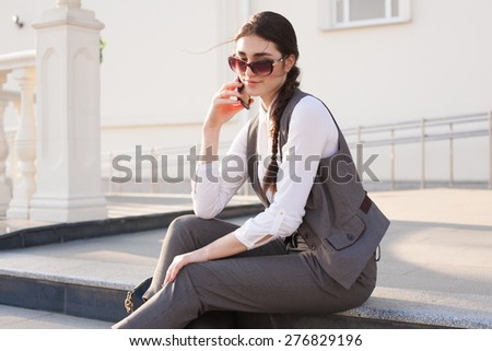 beautiful sensuality elegance lady brunette woman happy face with gray business suit white blouse, urban city professional portrait, nature lifestyle, background slim body, sunglasses red smart phone