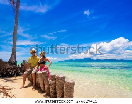 beautiful sexy woman and man with sunglasses in beach, bikini, hat, blue sun sea tropical nature background luxury  resort island palm about coral reef, tan sport athletic body, people holiday