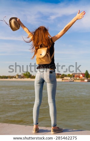 beautiful sensuality elegance lady haired hair woman happy fun back black t-shirt jeans urban city portrait nature slim sport body river blue sky river water ass