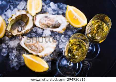 beautiful appetizer oysters and alcohol two glasses wine champagne luxury life background studio food