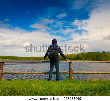 amazing beautiful elegance back haired hair man jeans and jacket black backpack blue sea ocean lake water sport body way horizon portrait nature urban city day