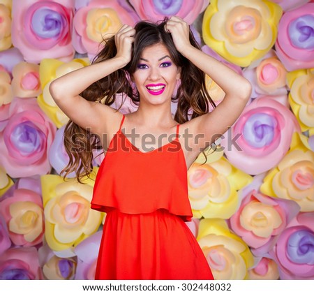 Beautiful amazing sexy elegance lady brunette woman, has joy fun smiling tan face, brown eyes, pink makeup, red dress, long hair, slim body. Studio portrait.