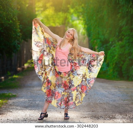 Beautiful amazing sexy elegance lady blonde woman, has joy fun smiling face, pink shirt, color skirt, slim body. Nature  summer sunny portrait. Country style.