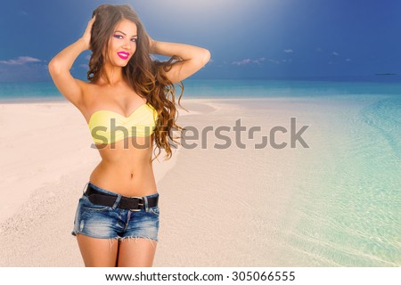 Portrait pretty fun joy sexy smiling brunette woman, has yellow bikini bra, blue jeans shorts, tan face and  body. Sun tropical hot blue sea water resort. Travel rest nature. Amazing lifestyle