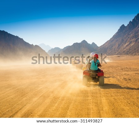 Motorcycle safari in the land Egypt. People travel. Beautiful  holiday background. Extreme hobby games.  Speed achievement tracking. Amazing desert Sharm.