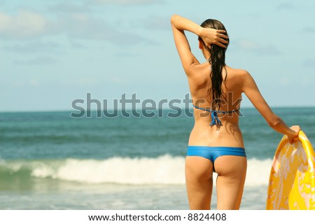 Bikini Girl with boogie board on the beach