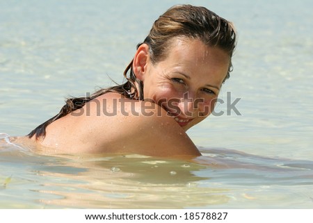 woman takes a bath in ocean by very good day