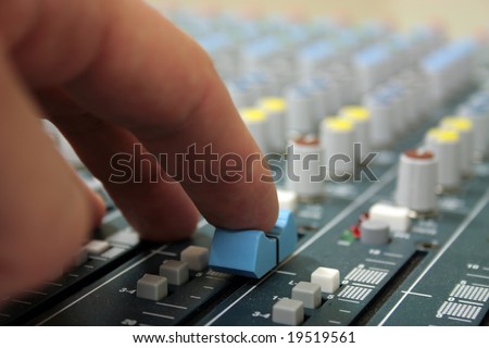 hand of sound engineer on the sound mixer