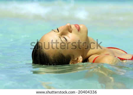 close-up of woman face in water by caribbean sun