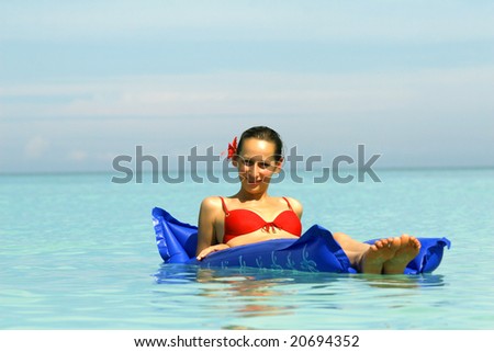 Woman On An Air Mattress in ocean