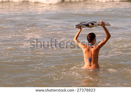 woman with boogie board in the ocean