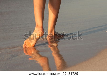 female feet, walking on the caribbean beach