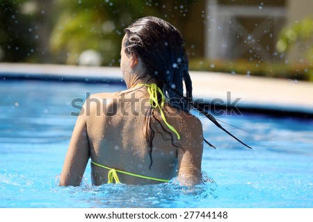 woman takes a bath in the swimming pool
