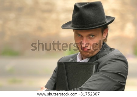 angry businessman with folder on the street