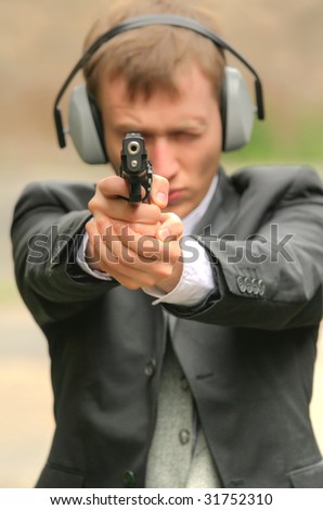 detective aiming with a gun into the camera