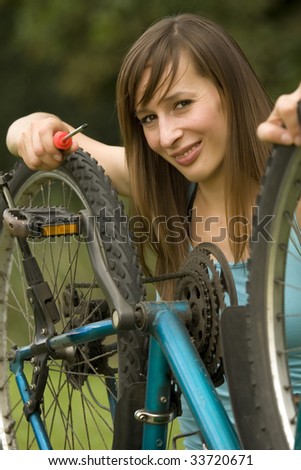 woman repairing the bike outdoor