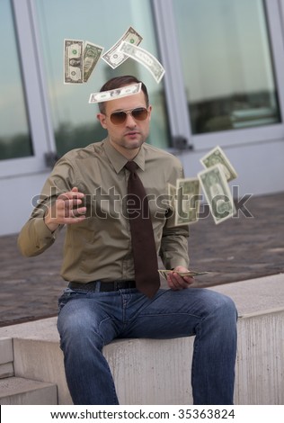 businessman in sunglasses throwing the money in the air