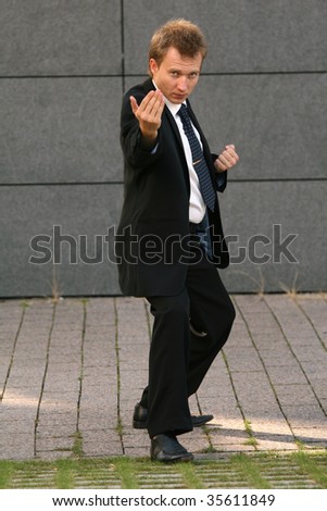 businessman in fighting position on the street