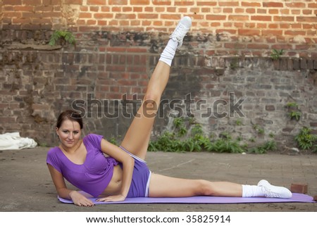 fitness woman doing sport exercises on the street