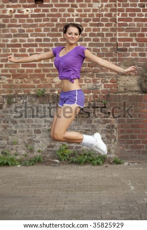 happy fitness woman jumps in the air