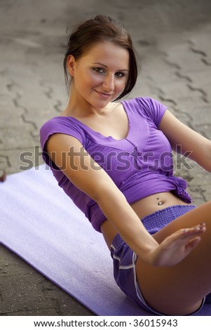 fitness woman doing sit-ups exercises on the ground