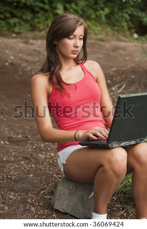 woman working with laptop in a natural outdoor setting