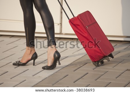 woman pulling her luggage on the street