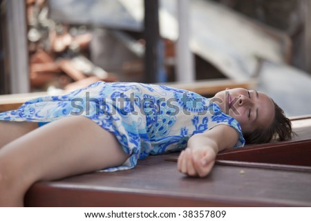 unconscious woman lying on the street after accident