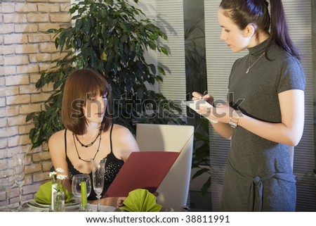female waitress takes order in a restaurant