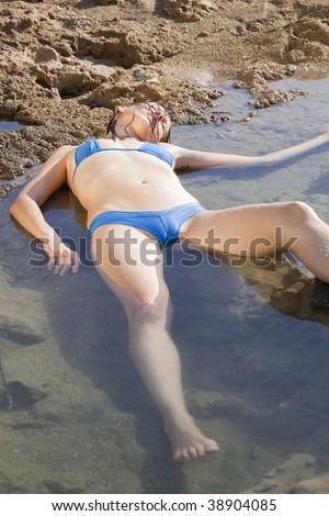 model playing a drowning woman lying in water