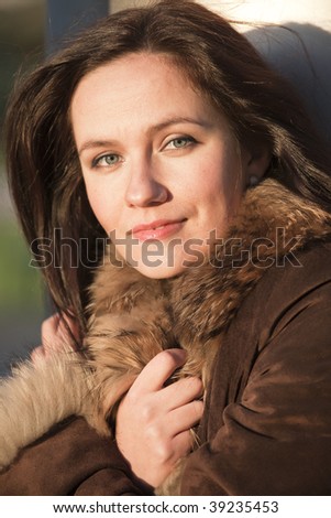 portrait of woman in fox coat by sunset