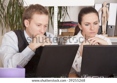 man and women thinking about a project in the office